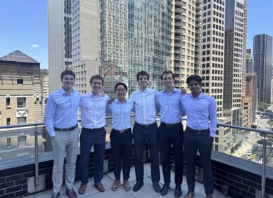 Romain and five fellow interns on a rooftop terrace in New York City
