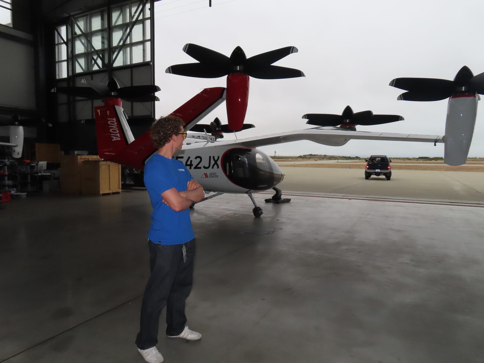 Romain standing in a hangar in front of a Joby eVTOL aircraft