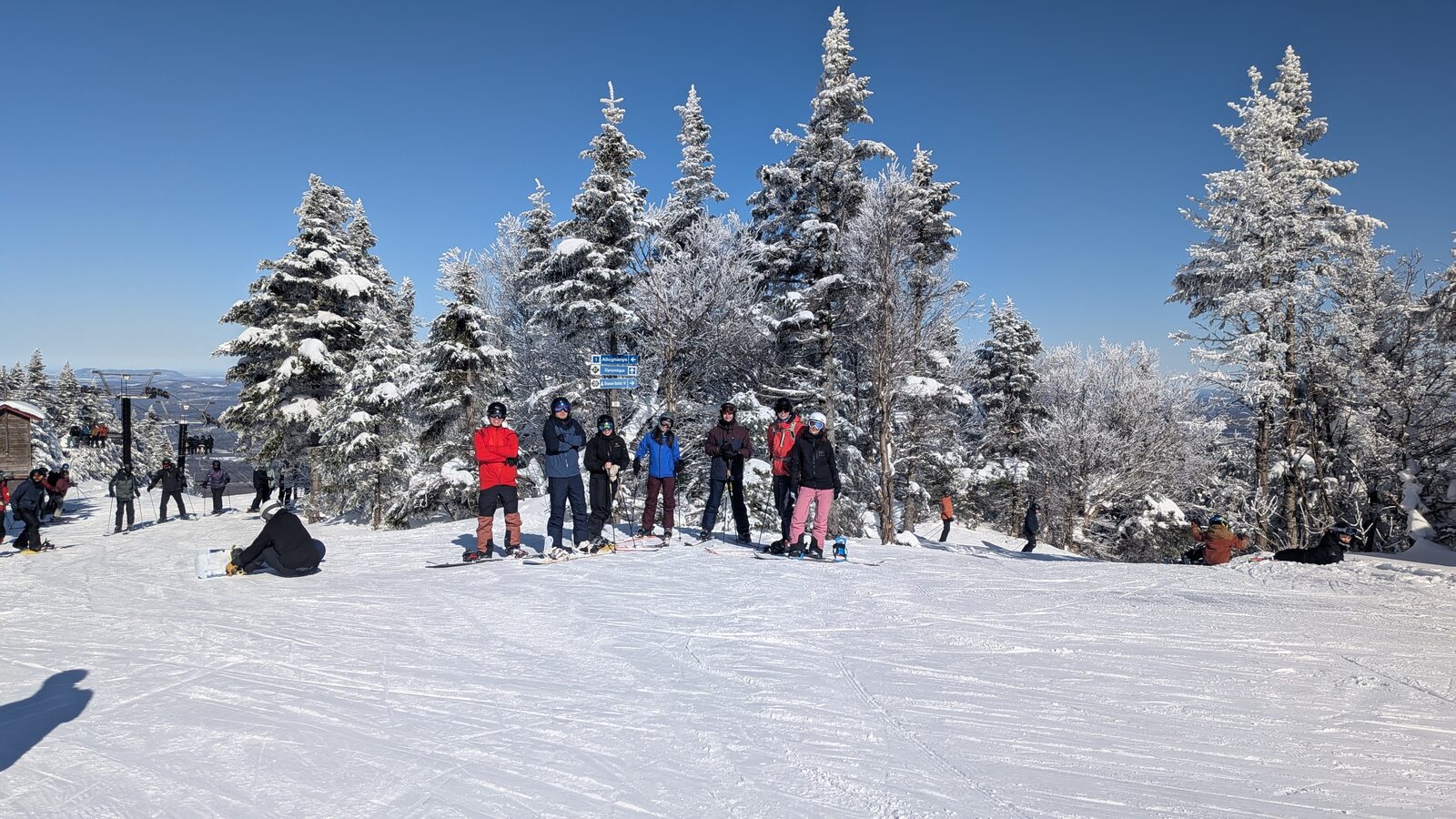 Romain and friends skiing at the top of a snowy mountain
