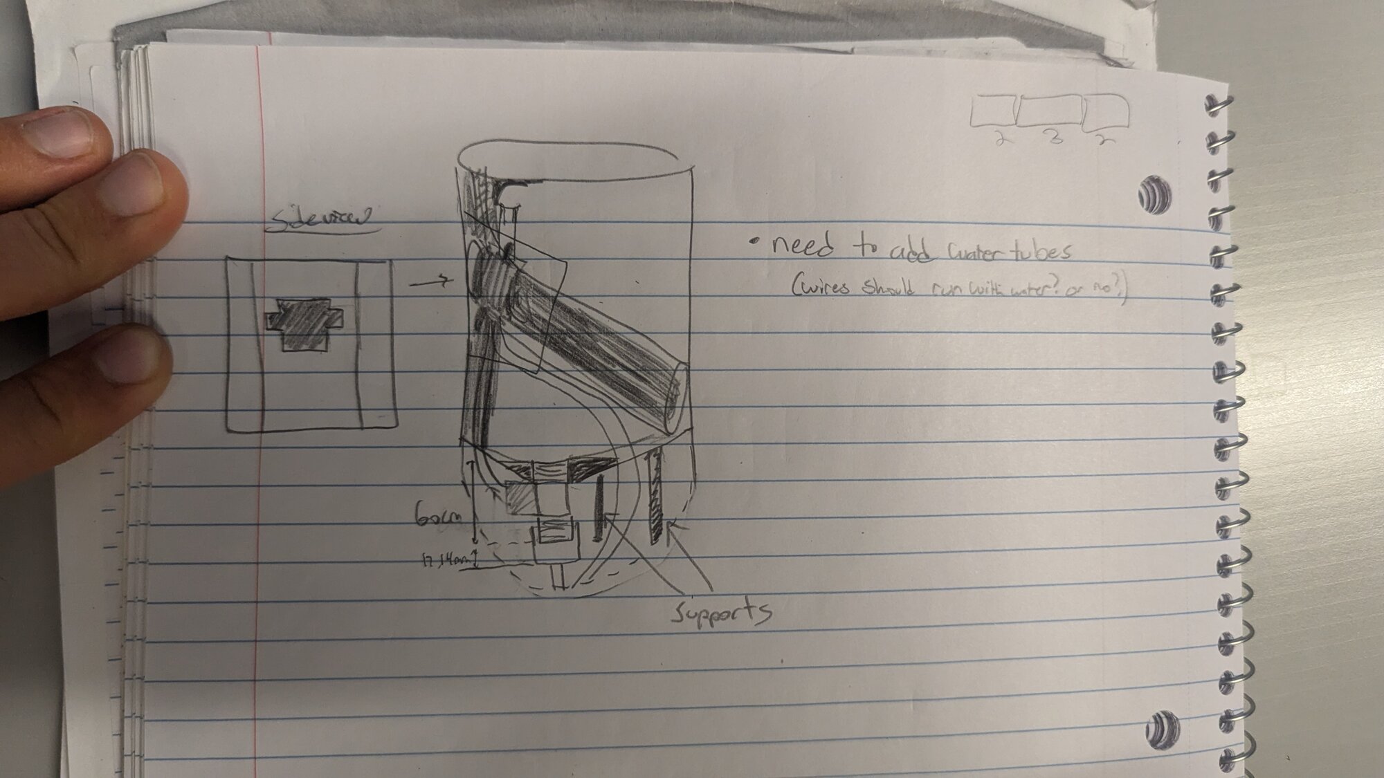 Hand-drawn side-view sketch of the payload tank showing the angled pump, water tubes, and support structure, with dimensions noted